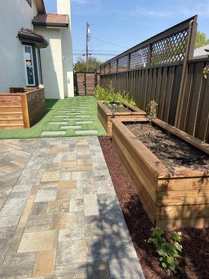 Paver Patio including Synthetic turf w/ Stepping Pads. Wooden Vegetable built to the side. 

Name : Quarry Stone 
Color : Sequoia Sandstone