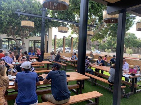 Beer garden features family style picnic tables good also has corn hole on the lawn (not photographed)