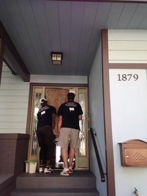 Extremely heavy oak armoire being carried by four (two pictured) English Gents.