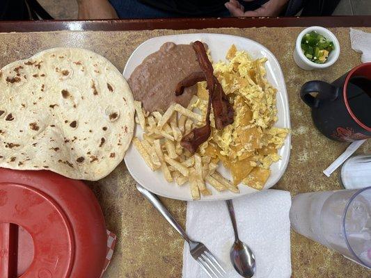 Migas plate, extra side of bacon, and fresh tortillas.