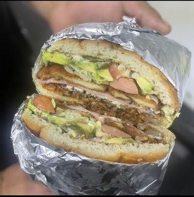 Torta Cubana  Ham, steak, pastor, breaded chicken, salchicha, cheese, lettuce, tomato, avocado, mayonnaise, beans & pickled jalapeños