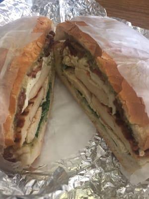 Grilled chicken sandwich with pesto, mayo, fresh mozzarella, spinach and bacon.