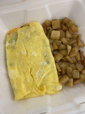 Veggie omelette and home fries. Omelet has fresh spinach and mushrooms, cheese, tomatoes, onions and green peppers