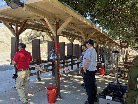 Range masters have red shirts. Orange buckets for shells.