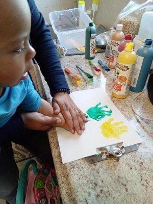 My son painting at daycare