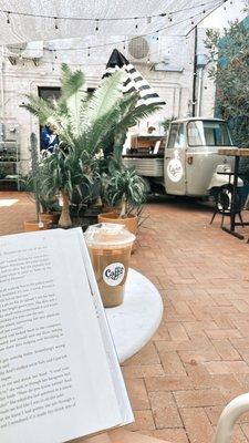 An iced chai latte in the courtyard