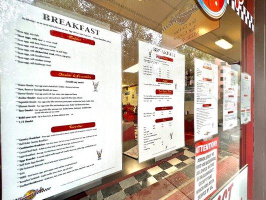 Breakfast menu on the front glass of cafe.