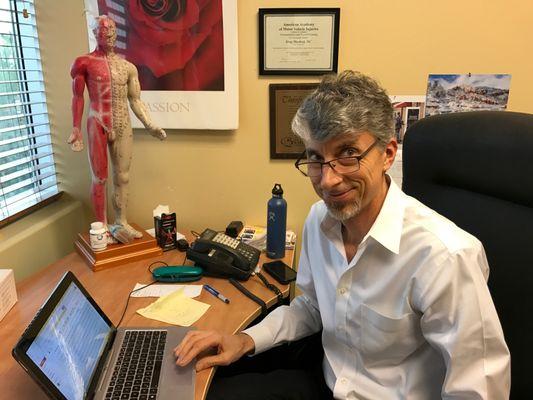 Dr. Greg Muchnij caught behind the scenes in his office.