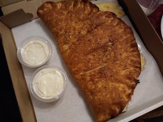 HUGE CALZONE! Buffalo chicken made vegetarian with plant-based chicken--totally STUFFED! For our soccer son who can handle the carbs. :-D