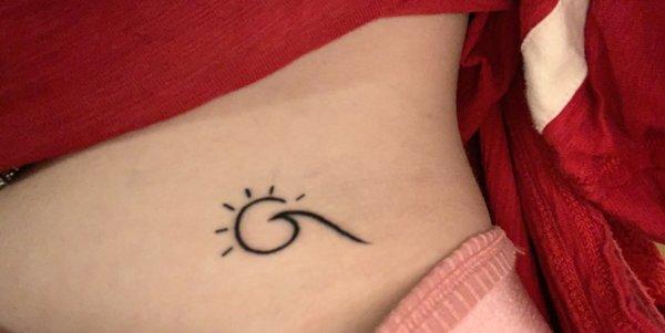 sun/wave tattoo on stomach