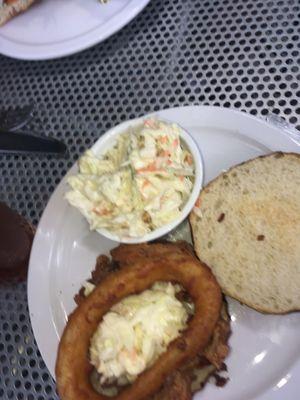 Pulled pork on a pretzel bun with coleslaw