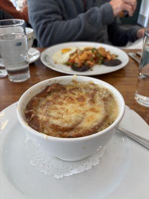 Piping hot onion soup -- lobster hash for the other diner. Where is the baguette?