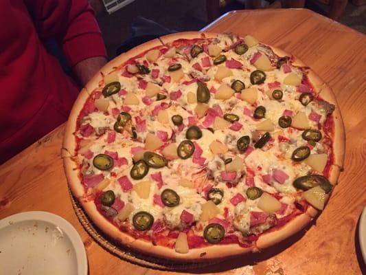 Hawaiian pizza with jalapeños and sausage on medium crust.