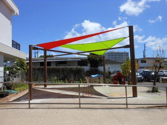 Sails installed on the front playground to shade the children during outdoor play.