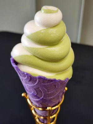 Matcha tea and vanilla cream swirl in a purple cone