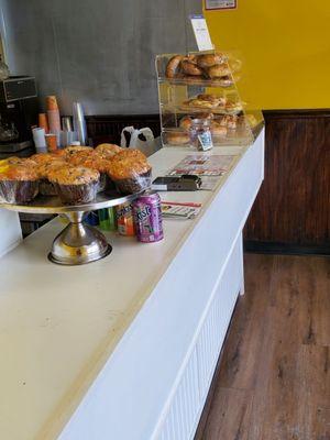 Some bagels and breakfast pastries on the counter.