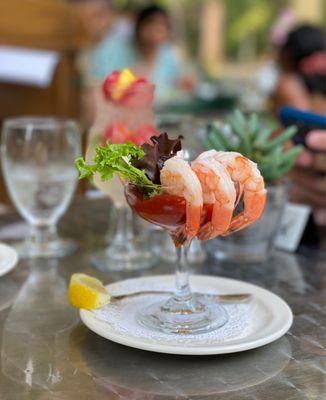 Shrimp Cocktail and a Strawberry Mojito in the background.