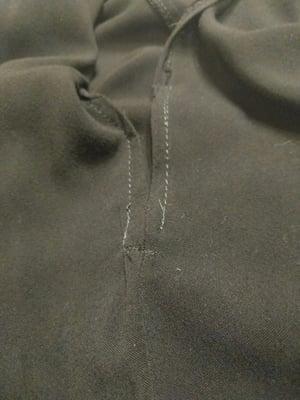 Open/unfinished hem on side slit