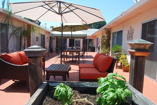 Patio with seating and raised gardening beds at Crown Bay Nursing and Rehabilitation Center