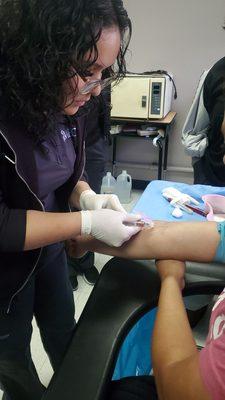 My friend practicing blood draws (venipuncture).