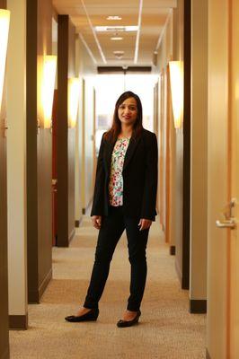 Renton dentist Dr. Pawandeep Kaur standing in the hallway at Renton Smile Dentistry