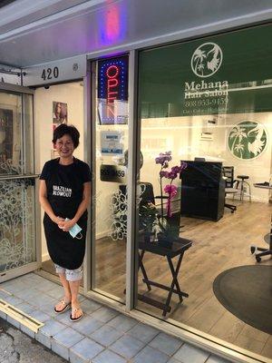 Business owner, hair stylist Anna in front of her shop