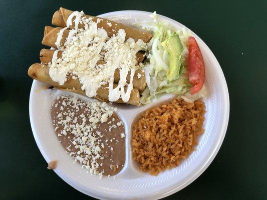 Flautas with rice, beans and salad.