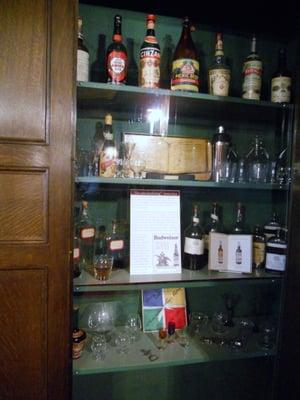 liquor cabinet built in behind paneling in main entry hall