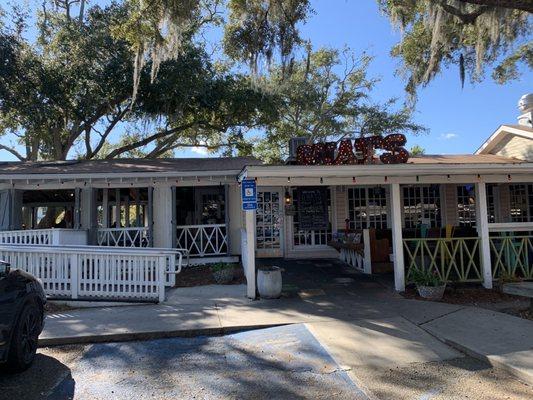 Exterior. Outdoor covered seating on left side and front. There are outside tables as well off the back.