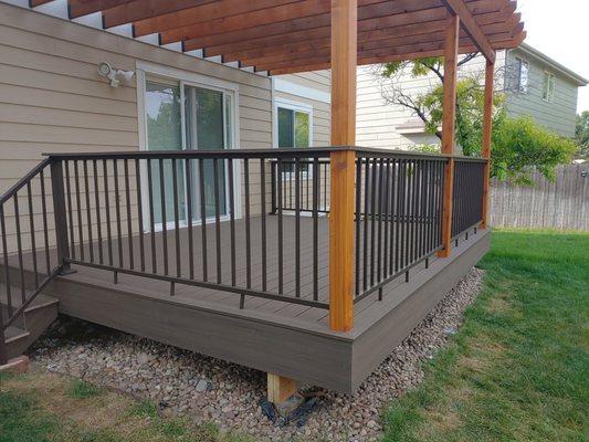 Composite deck with metal railing and cedar pergola.