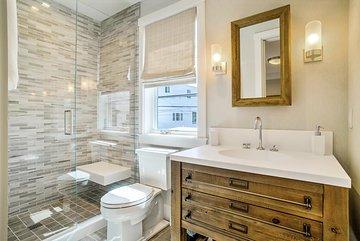 WHY NOT mix it up?! Sleek solid surface countertop and shower seat, rustic vanity with multi-tile create amazing visual texture