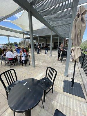 Covered outdoor patio seating area with wood fired pizza oven