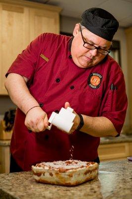 Adam teaching a cooking class on making lasagna