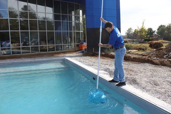 Drew cleaning our pool.