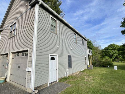 Siding replacement in Danvers MA.  Replaced wood clapboard siding with vinyl siding.  New gutters.