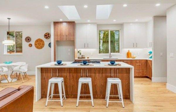 Staged kitchen with natural wood cabinets and blue accents.