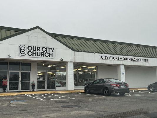 Church entrance double doors on left, City Store + Outreach Center double doors on right.