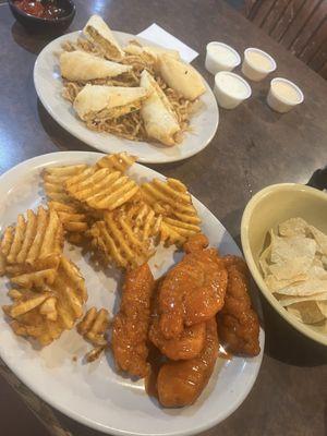 Arizona Egg Rolls on a bed of fried onion straws with southwest ranch sauce;  and buffalo chicken platter with waffle fries.