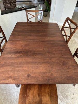 Most likely sweat that dripped on table while staining or wet brush used and table not dried before sanding