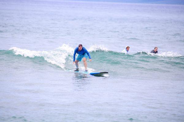 Surfing near Lahaina during a Maui Surfer Girls private lesson. Photo by Maui Surfer Girls photographer Krystal.