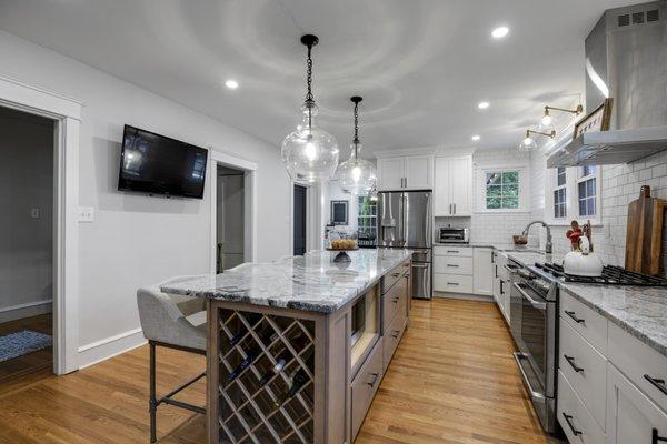 Kitchen remodeling. Large island with seating. White shaker cabinets. White subway tile backsplash. Cabinet installation. Philadelphia, PA.