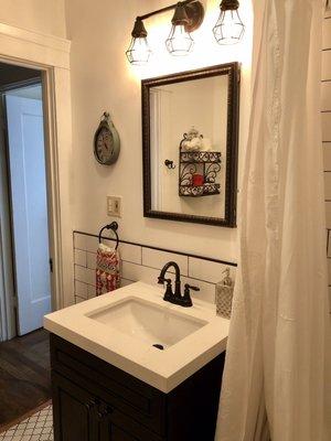 New medicine cabinet! Edgar put the half wall of tile exactly as I requested.  Now the outlets match :-D