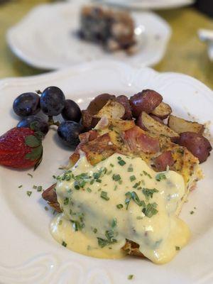 Breakfast quiche with a side of potatoes and fruit