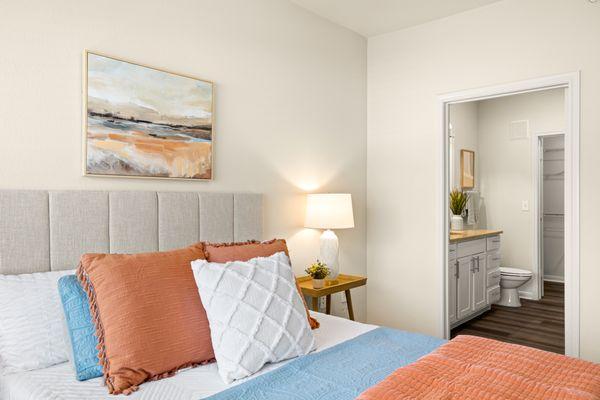 Bedroom with view of bathroom at Onion Creek Luxury Apartments