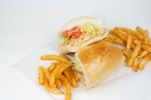 Grilled chicken sandwich with lettuce and tomato, with crispy fries.