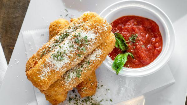 Homemade Mozzarella Sticks - Smoked mozzarella chunky sticks coated in breadcrumbs served with spicy tomato sauce.