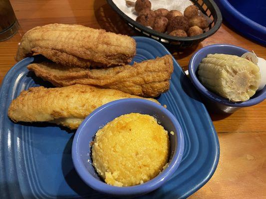 Flounder dinner with cheese grits & corn on the cob. Hushpuppies were for the table.