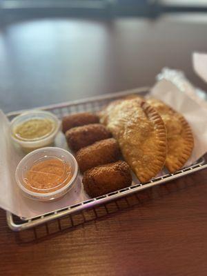 Empanadas and croquetas with sauces