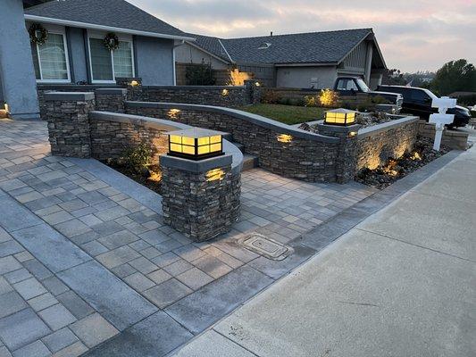 New interlock pavers plus chemical finish concrete surrounding the pavers.  New outdoor lighting and low maintenance front yard.