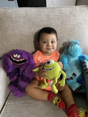 Baby Boy happy with his Monsters Inc stuffed animals